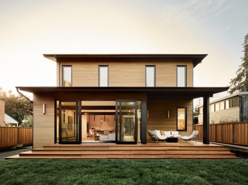 From the living room, dual sets of doors open to the deck and to the grassy backyard.