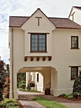 OUT OF SIGHT: A handsome porte cochere shields the three-car garage from full frontal view and creates a feeling of arrival. "So often the general marketplace would look at a lot like that and still put the garage on the front, then struggle to engage it into the body of the house," says LRK architect Carson Looney. "They'd dress it up with windows and shutters, but it would still dominate the street. And when you do that with a lot this shape, you end up with a backyard that's so deep and narrow it's useless."