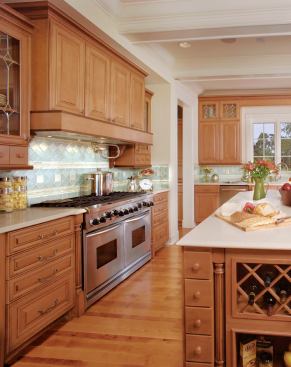 DOUBLE DUTY: The main kitchen doesn't mess around when it comes to functionality. Double ovens topped by an industrial-strength, eight-burner range and a pot filler are designed to accommodate every scenario, from everyday dinners for a big family to fabulous five-course holiday feasts. A distance of 43 inches between the island and the wall counters ensures plenty of room for multiple cooks.