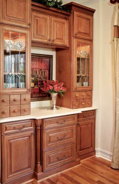 ELEGANT STORAGE: Every family kitchen needs places to store the electronic gadgets that are a must these days. Said storage also needs to be attractive. The Reality House has both. The kitchen and breakfast room are outfitted with furniture-quality cabinets from Timberlake Cabinet Co. The Mitered Maple Mocha with Derbyshire Seeded Glass features solid wood fronts and drawer boxes, dovetail joinery, and full-access drawers. French Twist knobs and drawer pulls complete the look. www.timberlake.com