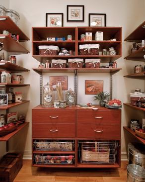ORDER IN THE FORT: Modular shelves by Schulte in the walk-in pantry provide vertical storage for bulk food purchases, backup kitchen staples, and nonrefrigerated produce.
