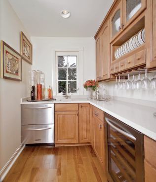 THAT’S ENTERTAINMENT: The butler’s pantry off the formal dining room includes a wine fridge and storage space for fine china and stemware, plus a KitchenAid drawer dishwasher, so dirty dishes don’t have to travel far.