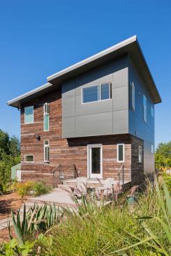 Reclaimed fir car decking was re-milled into thinner sheets and applied as a rainscreen for most of the exterior siding. Pre-painted HardiPlank clads the rest of the exterior.