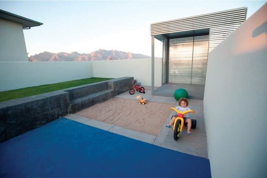 Simple forms, sturdy materials, and plenty of room for creative play make this outdoor space a magnet for young children.