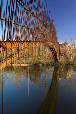 The vertical lines of the footbridge railing are meant "to be a continuation of the reeds on the shore," says architect Miguel Rivera. "It's a simple idea that came from the site."