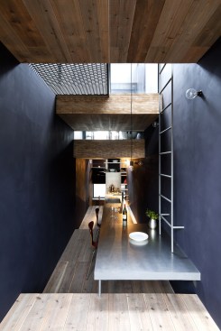 Light from the third floor pours into the living, dining, and kitchen area, where the neutral color palette exudes a minimalist design.&nbsp;