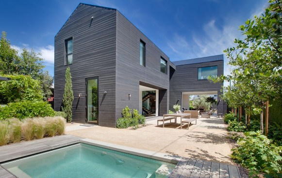 The house’s massing is expressed by contrasting horizontal and vertical sustainably-harvested wood rainscreen siding.