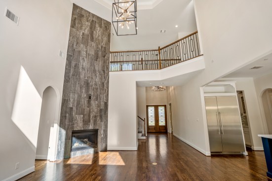 Living Room viewing custom floor to ceiling tiled fireplace