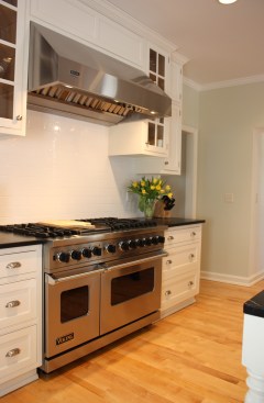 This farmhouse had received several updates and renova-
tions over the years. However, the floor plan was conflict-
ing amongst the kitchen, laundry, mudroom, and powder 
room. A complete reorganization of the first floor was 
achieved through multiple structural changes that al-
lowed for a larger kitchen and created better flow be-
tween adjacent rooms. The kitchen includes custom 
painted cabinetry, a farmhouse style sink, and soapstone 
countertops. A commercial size Viking range, hood, and 
Sub Zero refrigerator bring a theme of stainless steel to 
the kitchen which is accentuated by brushed nickel hard-
ware and island faucet. Specialty lighting, glass door 
cabinets, and a grand, eight foot island are just a few of 
the features that make this kitchen stunning.