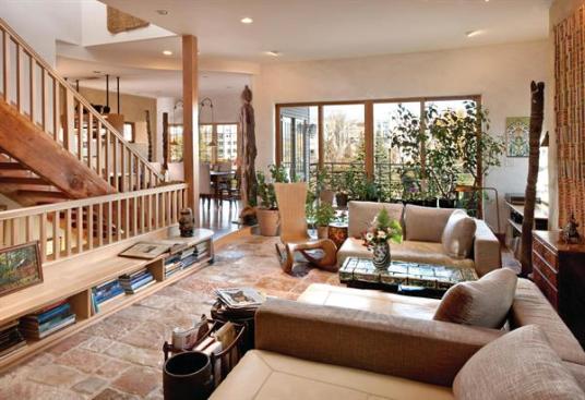 Warm, well-worn materials add character and up the sustainability quotient, including reused stone flooring and bookshelves and trim made of salvaged lumber from a nearby teardown. 