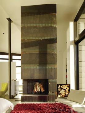 The master bedroom's fireplace is fabricated from the same plate steel that clads sections of the exterior.