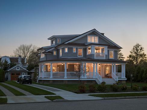 On the site was an existing house, but it was too cost prohibitive to renovate. "In this beach town and neighborhood, porches are a huge design element,” says architect Rich Bubnowski. Entrance steps are 12 feet wide, and it's the favorite spot for portraits taken during family gatherings. The original porch was 13 feet deep, and the scale has been maintained.