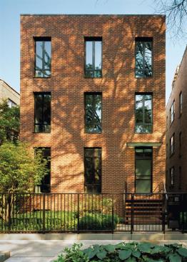 The understated street persona of this house, conceals a single-family adventure in architecture. A glass curtain wall opens the rear of the building to a walled patio.
