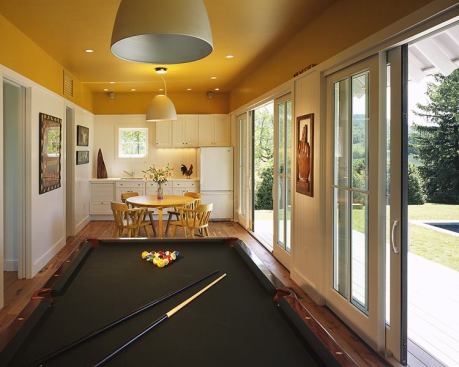 A different type of pool-the kind with cue sticks and green felt-occupies the pool house's first floor, which also contains a small kitchen for preparing quick refreshments.