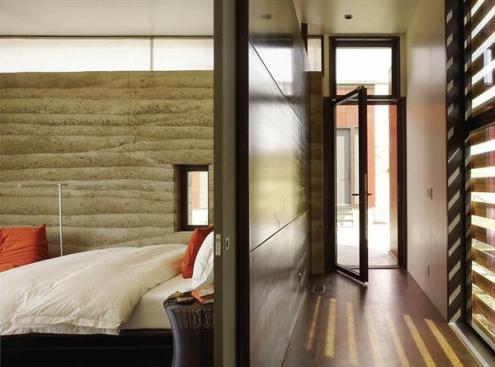 The secondary bedroom's rammed earth wall served as a trial run for the great room's longer version.