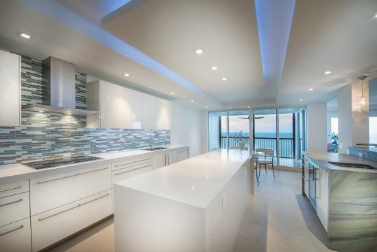 2014 Grand Winner, Kitchen Renovation: The Biltmore Residence, Naples, Fla. The rectilinear island and ceiling soffit draw attention toward stunning ocean view.