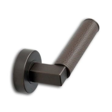 The manufacturer fabricates custom door hardware using brass and bronze as the base metal. Shown here in a dark finish, the piece is designed with a leather overlay on the handle. Various finishes are available. 
chantproductions.com.
