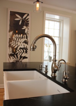 This farmhouse had received several updates and renova-
tions over the years. However, the floor plan was conflict-
ing amongst the kitchen, laundry, mudroom, and powder 
room. A complete reorganization of the first floor was 
achieved through multiple structural changes that al-
lowed for a larger kitchen and created better flow be-
tween adjacent rooms. The kitchen includes custom 
painted cabinetry, a farmhouse style sink, and soapstone 
countertops. A commercial size Viking range, hood, and 
Sub Zero refrigerator bring a theme of stainless steel to 
the kitchen which is accentuated by brushed nickel hard-
ware and island faucet. Specialty lighting, glass door 
cabinets, and a grand, eight foot island are just a few of 
the features that make this kitchen stunning.
