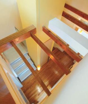 Old pine beams and oak floors peacefully coexist with vertical grain roasted bamboo wall panels, frosted glass, stainless steel, and a single sheet of aluminum that was bent to form stairs.