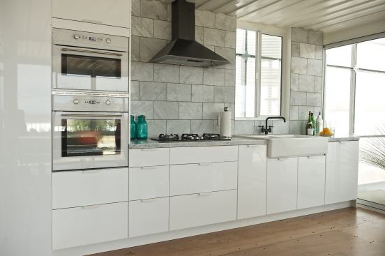 The floor in the&nbsp;&nbsp;kitchen (and throughout)&nbsp;is made from recycled Philippine mahogany plywood&nbsp;that can be easily sanded down and refinished.
