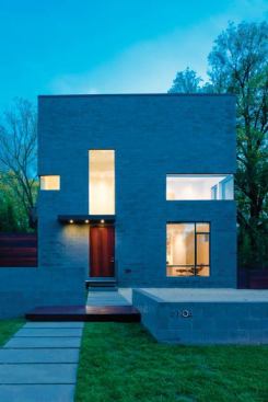 A vertical window extends this home’s entryway, allowing the door to act as a piece of the fa&ccedil;ade’s play on geometric cutouts. Project: Hampton Lane House, Bethesda, Md.; Architect: Robert M. Gurney, Washington, D.C.; Builder: Freedom First Homes, Bethesda, Md.