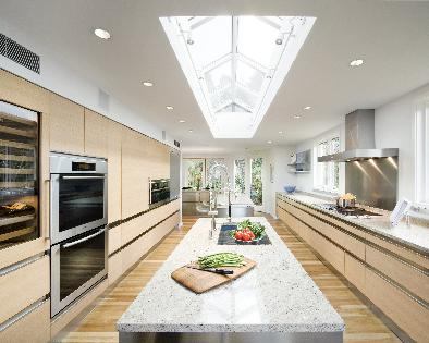 Tall wall units along the kitchen's support wall provide additional storage space as well as room for wall ovens, an appliace garage, refrigerator and more.