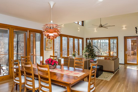 An entire wall (left) of the main living space is actually two sets of massive, triple-paned glass, Passive House-rated folding doors.