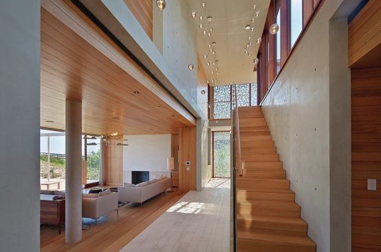 The screens bracket a stair hall, filtering eastern and western light into the middle of the house.