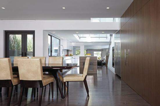 Combining the building’s two units yielded an expansive interior that centers on a bright two-story kitchen.