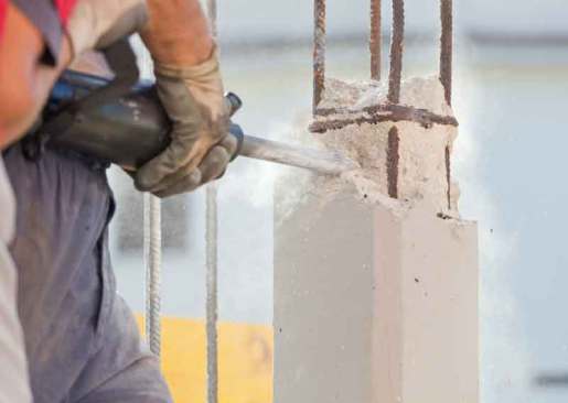 Foundation repair engineer cutting concrete pilars