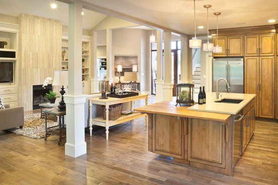 The details stand out: elegant columns provide a bit of definition
without closing anything off, a bookshelf holds treasured cookbooks, and
several doors open to the patio for easy indoor/outdoor entertaining.