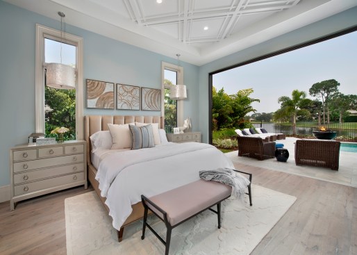 The bedroom in this model home designed by Marc-Michaels takes advantage of the Florida climate by creating a seamless indoor/outdoor space.
