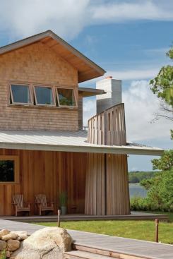 
        The narrow cedar boards are cut off in a
 pattern that mirrors the angle of the porch roof while the wider slats 
are canted in the opposite direction.
      