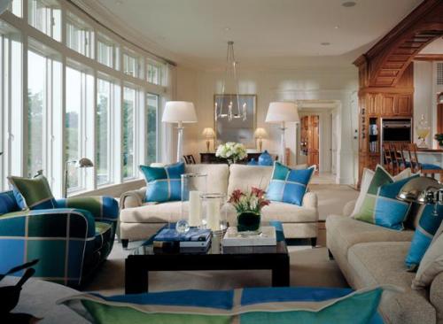 The homes many rounded features including the windowed living room wall, the corner fireplace and chimney, and the gently turning staircase recall the curvilinear lines of a boat.