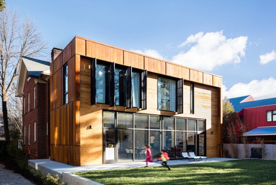 By keeping the addition's mass within the planes of the original house and dividing the public and private spaces between two floors, a backyard is retained on a narrow inner-city lot.
