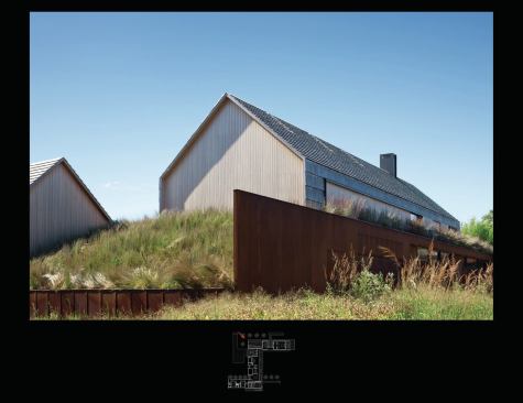 An earth berm creates a false ground plane, reducing the apparent scale of the main wing. The walk-out lower level is sided in Cor-ten steel.