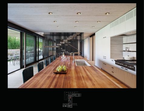 The innovative second-floor structure—7-inch-thick wood planks splined together to form a monolithic “slab”--serves as a finish ceiling at the first floor. Lighting fixtures are recessed into holes bored in the ceiling.