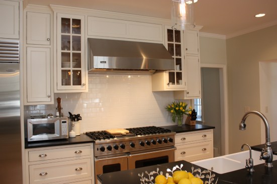 This farmhouse had received several updates and renova-
tions over the years. However, the floor plan was conflict-
ing amongst the kitchen, laundry, mudroom, and powder 
room. A complete reorganization of the first floor was 
achieved through multiple structural changes that al-
lowed for a larger kitchen and created better flow be-
tween adjacent rooms. The kitchen includes custom 
painted cabinetry, a farmhouse style sink, and soapstone 
countertops. A commercial size Viking range, hood, and 
Sub Zero refrigerator bring a theme of stainless steel to 
the kitchen which is accentuated by brushed nickel hard-
ware and island faucet. Specialty lighting, glass door 
cabinets, and a grand, eight foot island are just a few of 
the features that make this kitchen stunning.