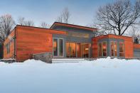 This modular home built on the California coast then packed flat for a cross-country trip to New York State shows no outward signs of its journey.