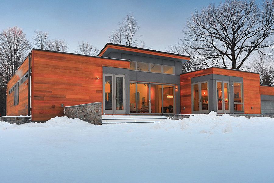 This modular home built on the California coast then packed flat for a cross-country trip to New York State shows no outward signs of its journey.