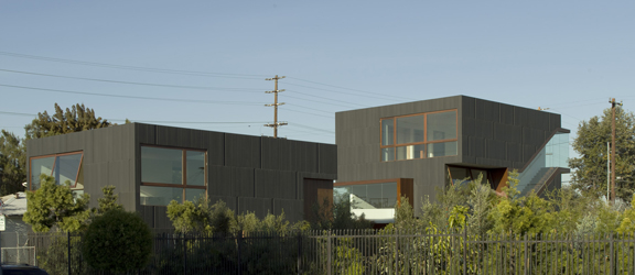 From the nursery, the two- and three-story volumes rise above the single-level homes in the neighborhood