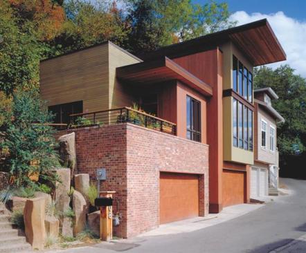 A mix of salvaged bricks and cedar siding clads both the guest house and the main house.