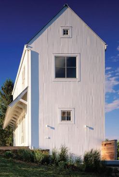 Two layers of vertical fiber-cement siding, intentionally left slightly uneven, create a woven texture for the exterior walls.