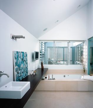 Sight lines from the kitchen and bath into other rooms expand the perceived size of both spaces.