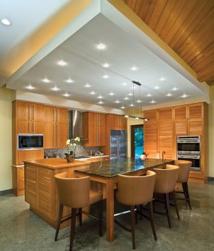 A triple-layered island provides a low countertop for food prep, a medium-height one for dining, and a tall one for socializing with the cook.