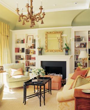 Thoughtful details like floating kitchen cabinets, opposite, and built-in living room bookcases, this page, give the house its blend of livability and panache.