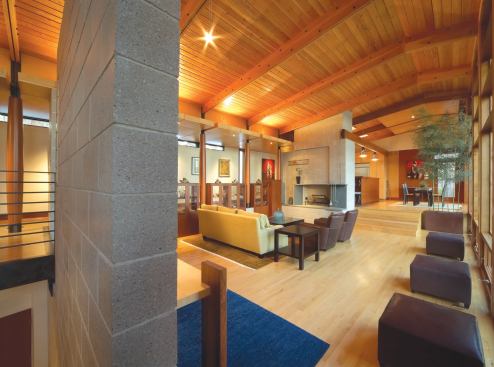 Interior spaces follow an informal layout, unified by the strong form of a low cathedral ceiling.