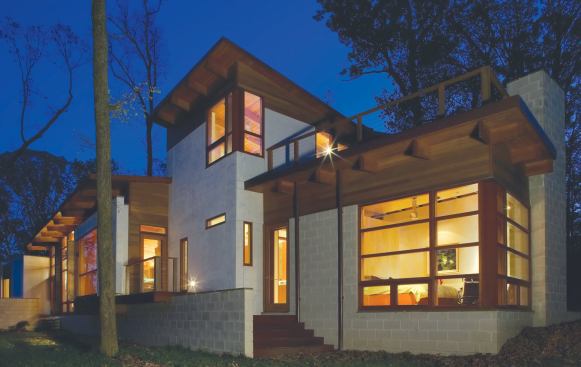 Strung along a sloping riverbank, this house flows with the contours of its site.