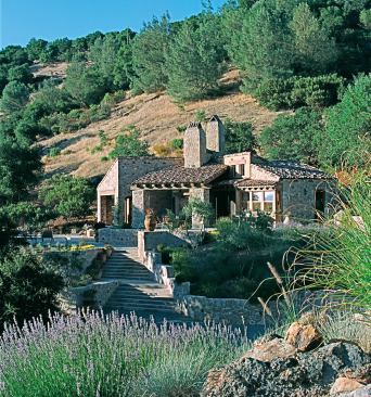 Most of the stone used for the house and retaining walls of this rustic-looking home came from the owner's vineyard down the hill. The house sits comfortably within a buildable area of the 65-acre site, looking as though "it has been there forever and has been added on to over the years," says architect Mario Aiello.