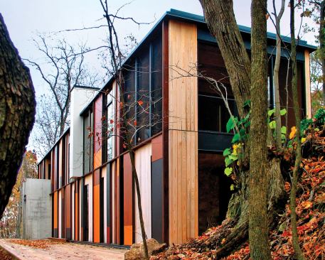 Stained siding panels reflect the colors of fall foliage.